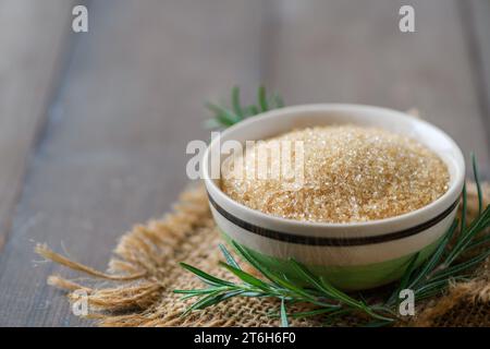 Brown sugar in bowl on wood background, Brown sugar adds flavor to desserts and baked goods````````` Stock Photo